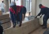 Expert Nairobi movers handling large furniture panels during a professional office relocation in Nairobi.