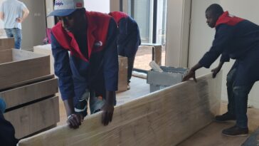 Expert Nairobi movers handling large furniture panels during a professional office relocation in Nairobi.