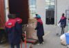 Nairobi Movers team in uniform loading household items and boxes into a large moving truck.