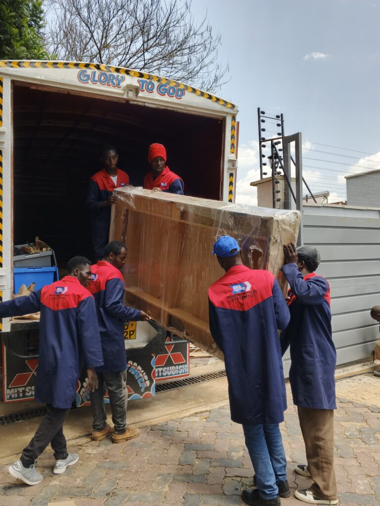 Professional house movers from Nairobi Movers safely offloading furniture